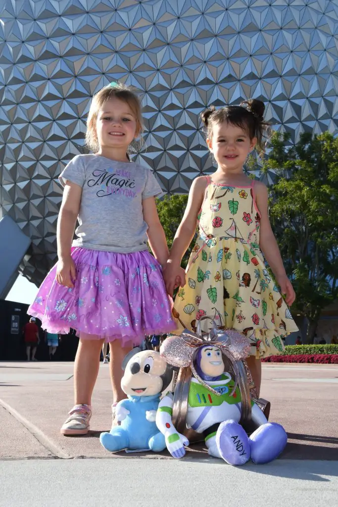 Little girls and stuffed animals in front of Spaceship Earth at Epcot