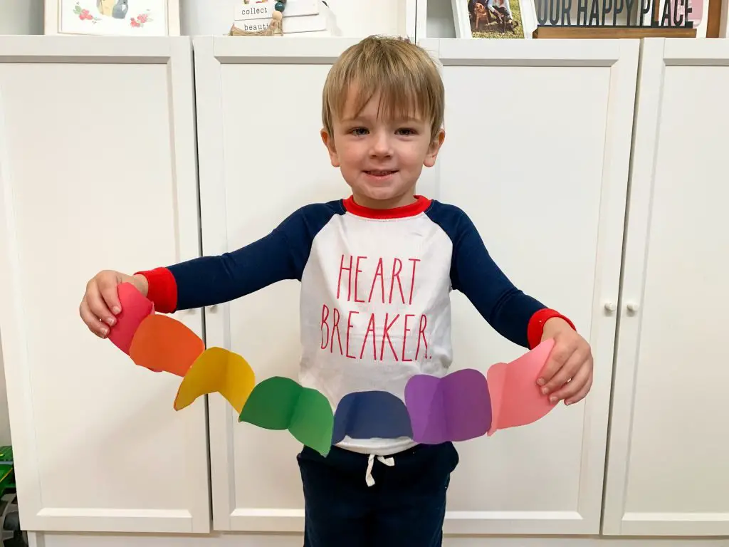 Toddler with his DIY heart garland!